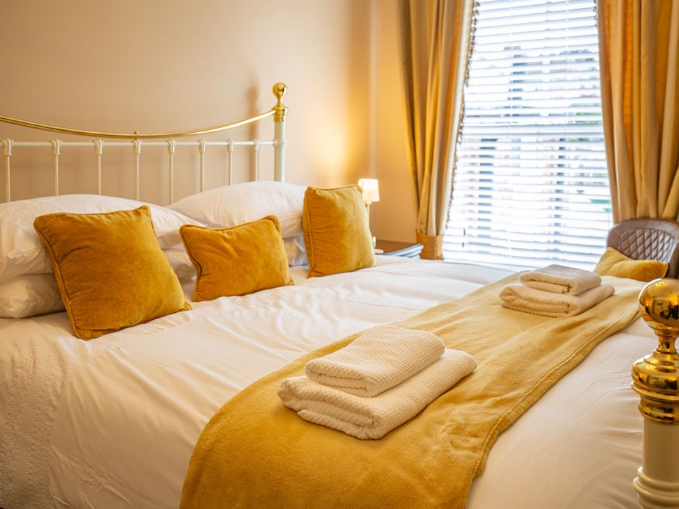 A bedroom with a bed and pillows at Hudson House
