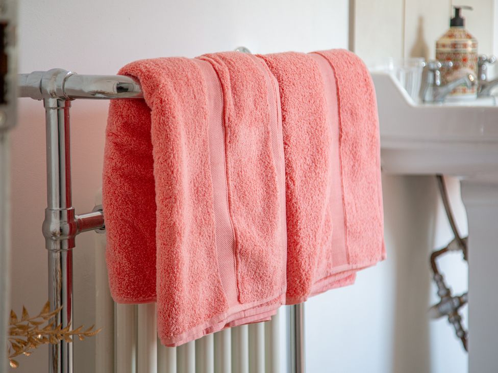 Towels hanging on a rack near a sink at Hudson House