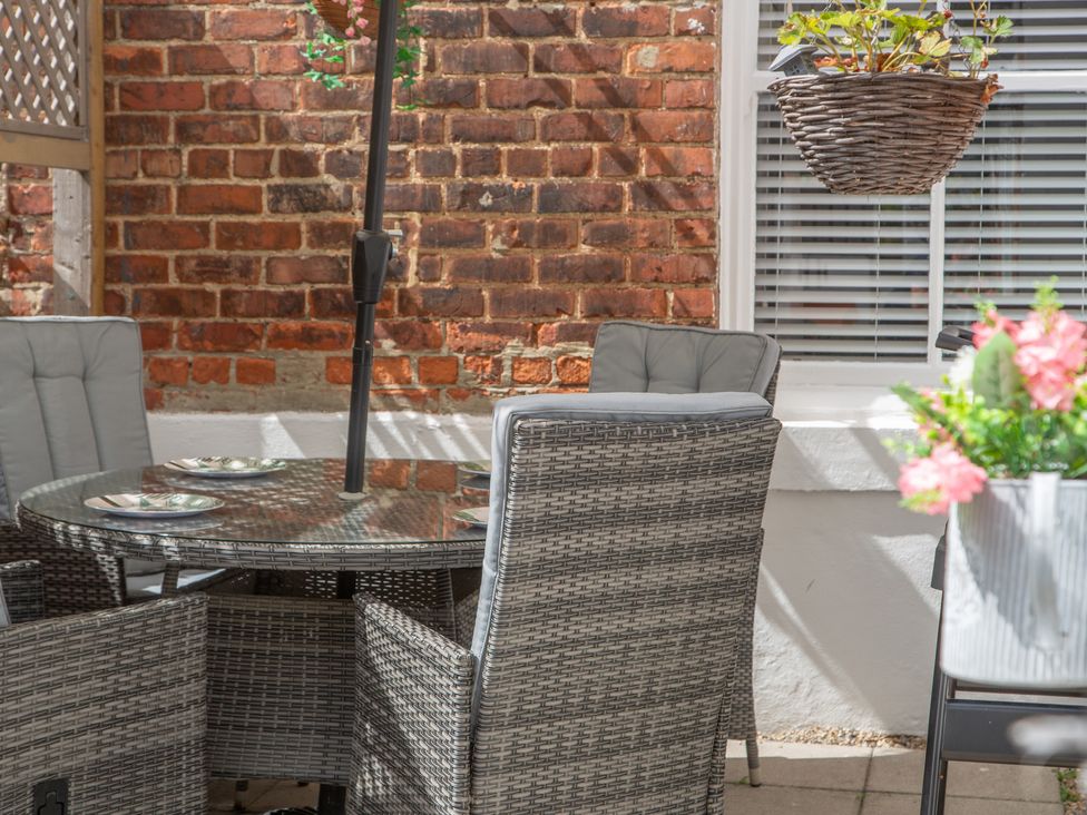 An outdoor dining area with a table and chairs at Hudson House