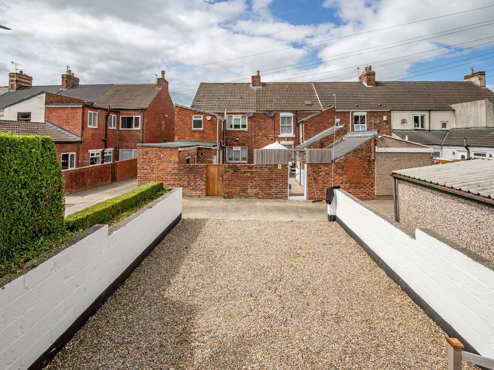 An outdoor view of houses and a gravel area at Hudson House