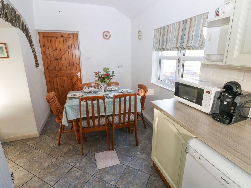 A dining room with a table and chairs at Barn Cottage in Haverfordwest