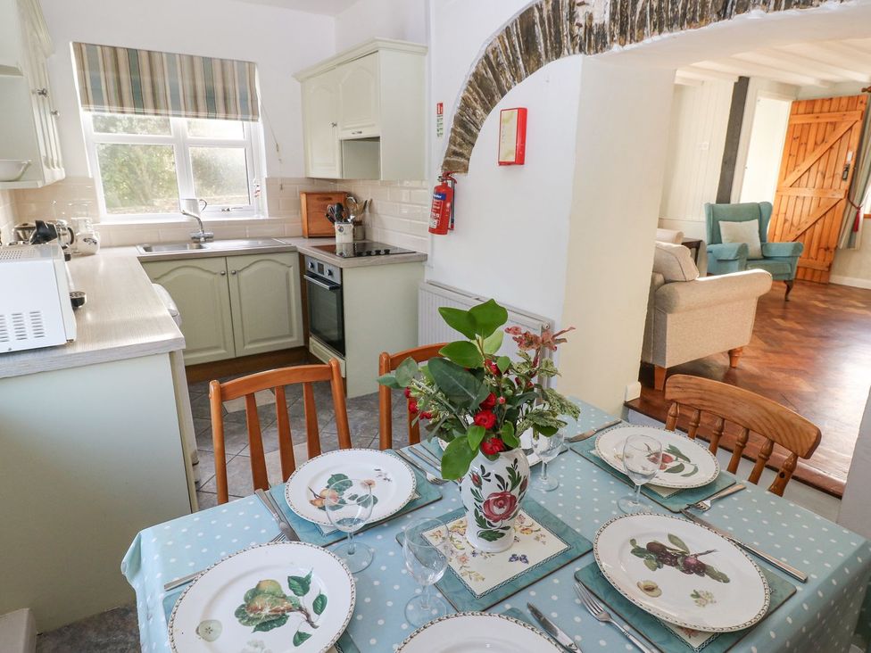 A kitchen with dining table and chairs at Barn Cottage Haverfordwest