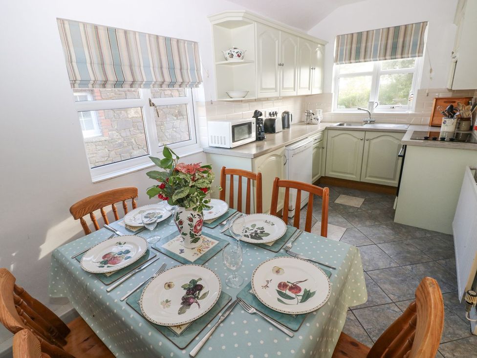 A kitchen with dining table set for a meal at Barn Cottage in Haverfordwest