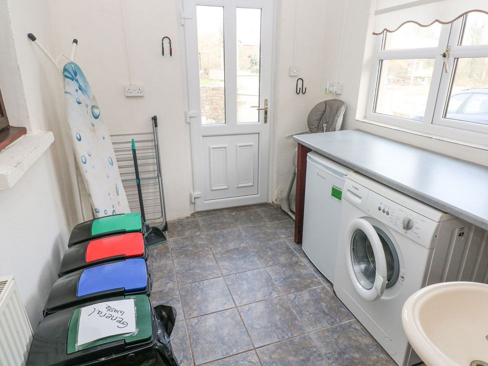 A utility room with a washing machine and sink at Barn Cottage Haverfordwest