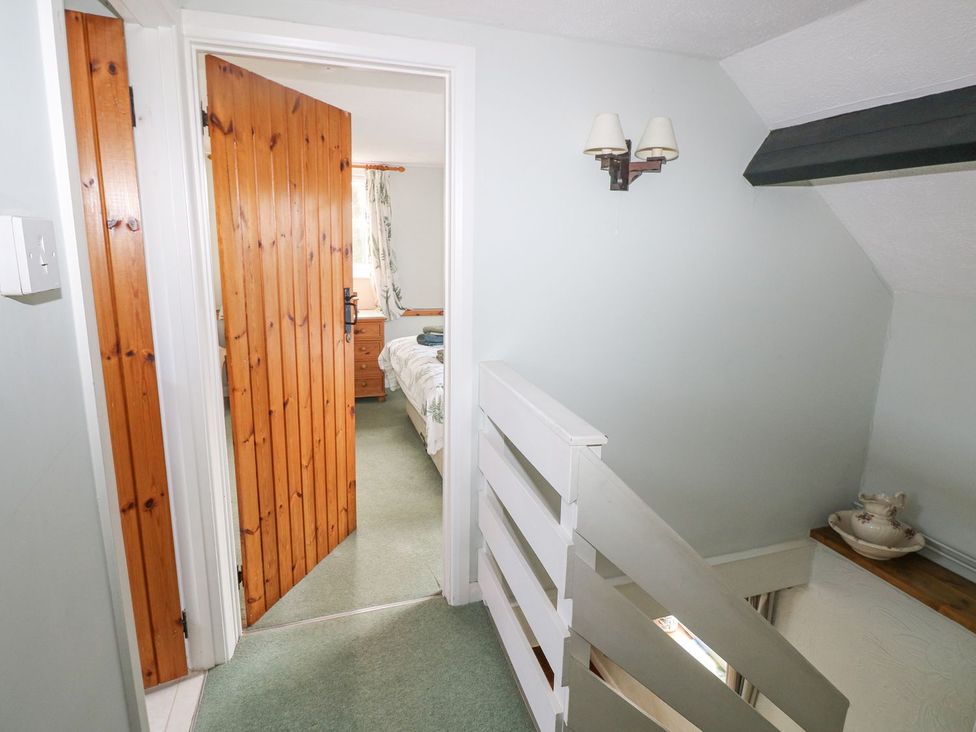 A hallway with doors and stairs at Barn Cottage in Haverfordwest