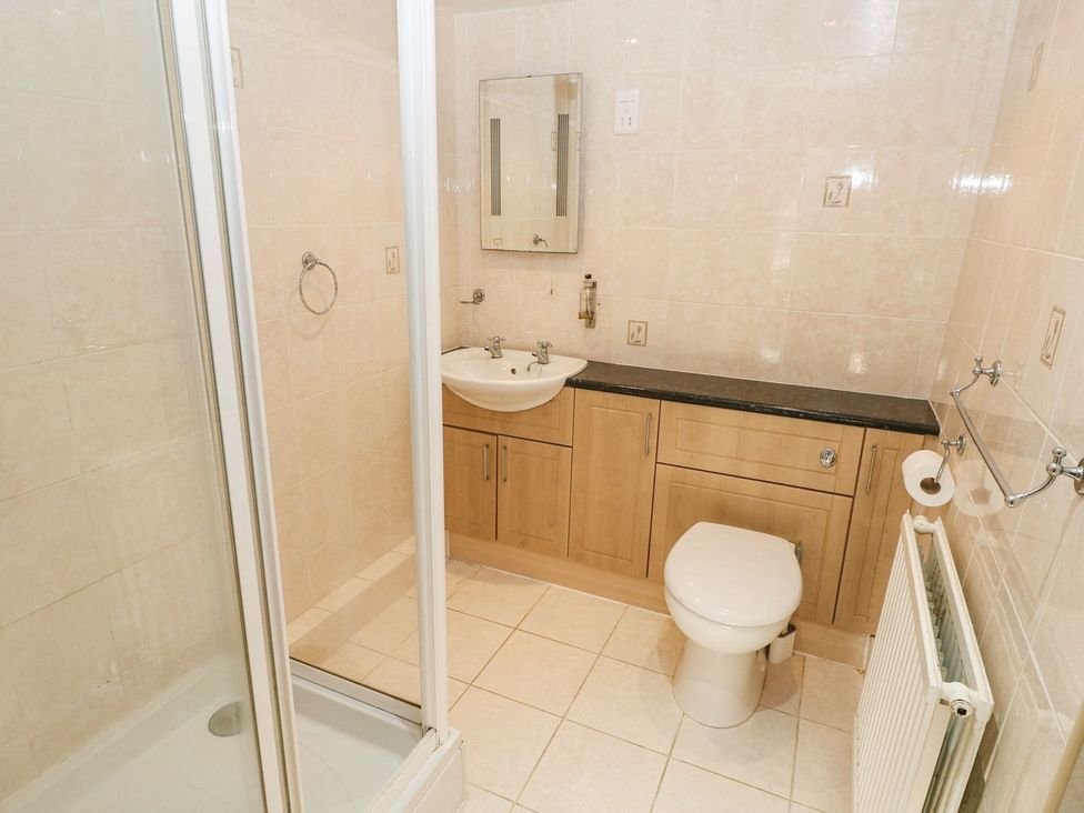 A bathroom with shower, sink and toilet at Barn Cottage Haverfordwest