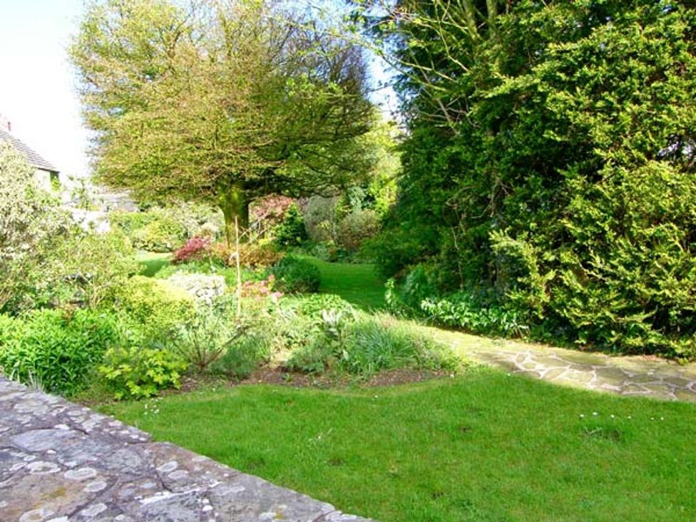 A garden with plants and a pathway at Barn Cottage in Haverfordwest