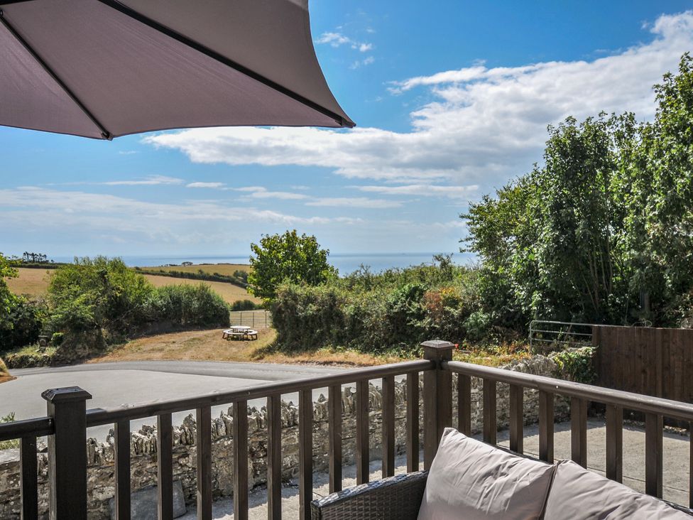 An outdoor view featuring a sea and trees at The Old Wagon House Torpoint