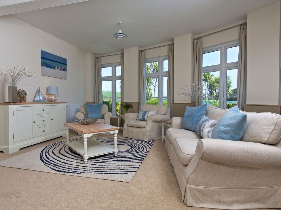 A living room with a sofa and armchair at 4 The Salcombe in Salcombe