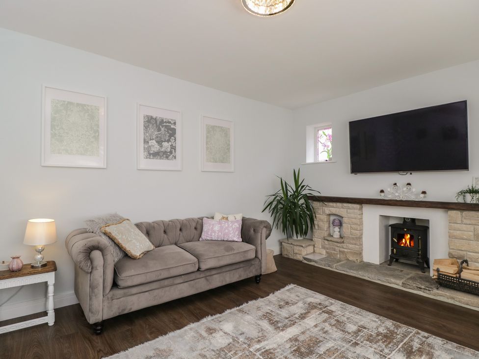 A living room with a sofa and television at The Laurels in Wimborne Minster