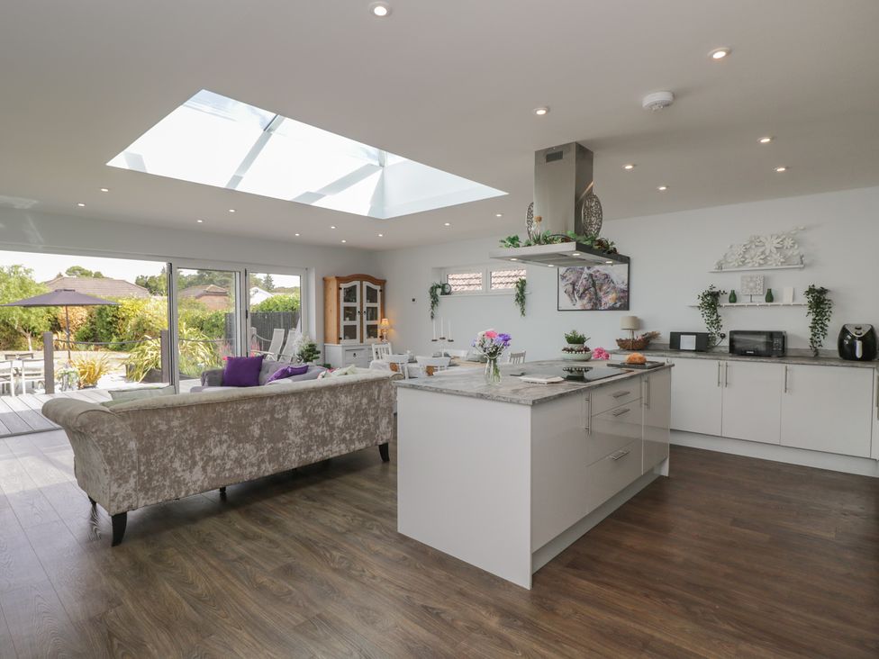 A kitchen with a sofa and dining area at The Laurels in Wimborne Minster