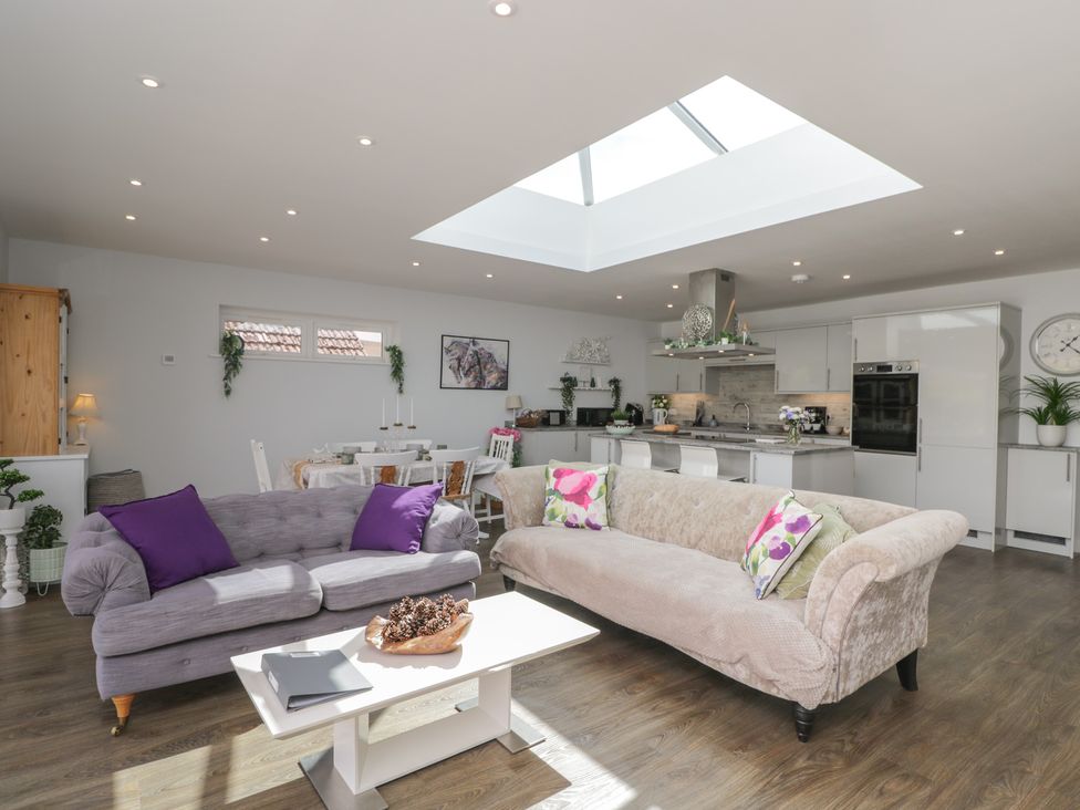 A living room with a coffee table and sofas at The Laurels in Wimborne Minster