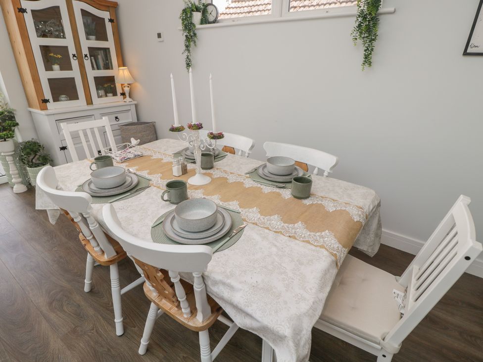 A dining room with a table set for a meal at The Laurels in Wimborne Minster