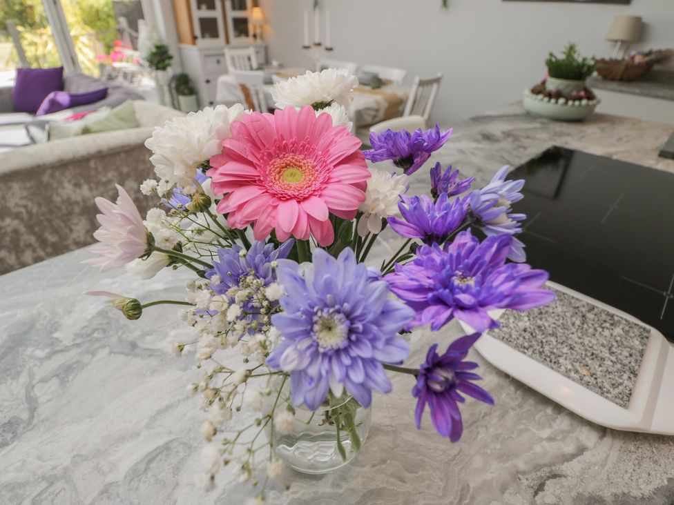 A vase of flowers on a table in the kitchen at The Laurels in Wimborne Minster