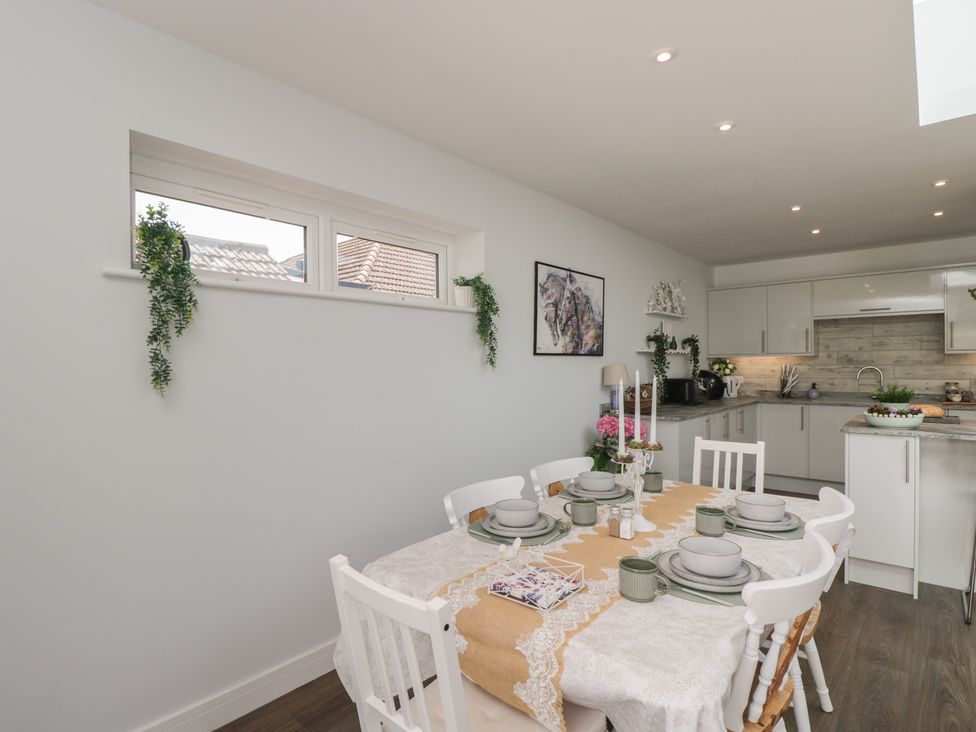 A dining room with a table and chairs at The Laurels in Wimborne Minster
