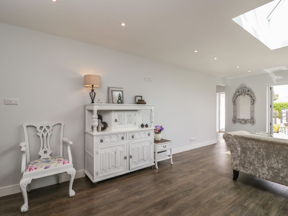 A living room with a cabinet and sofa at The Laurels in Wimborne Minster