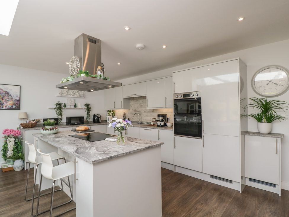 A kitchen with modern appliances and an island at The Laurels in Wimborne Minster