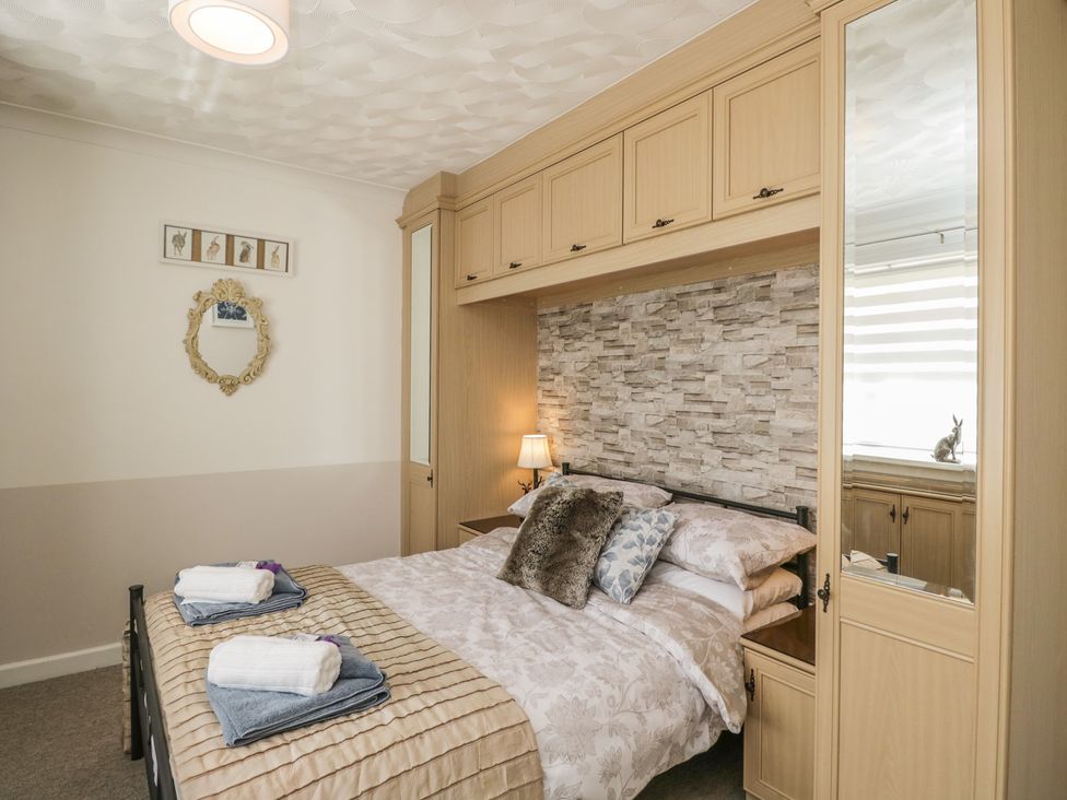 A bedroom with a bed and wardrobe at The Laurels in Wimborne Minster