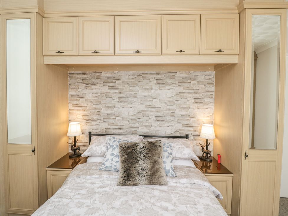 A bedroom with a bed and bedside tables at The Laurels in Wimborne Minster