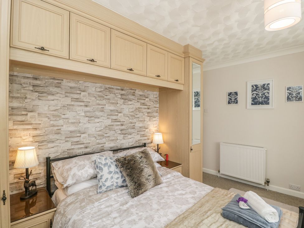 A bedroom with a bed and bedside table at The Laurels in Wimborne Minster