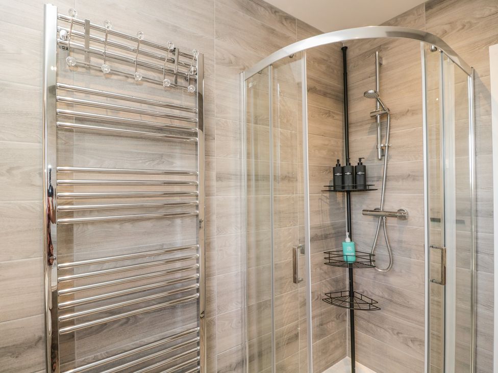 A bathroom with a shower and towel rack at The Laurels in Wimborne Minster