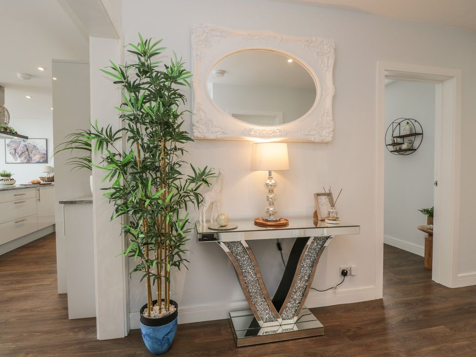 A hallway with a console table and lamp at The Laurels in Wimborne Minster