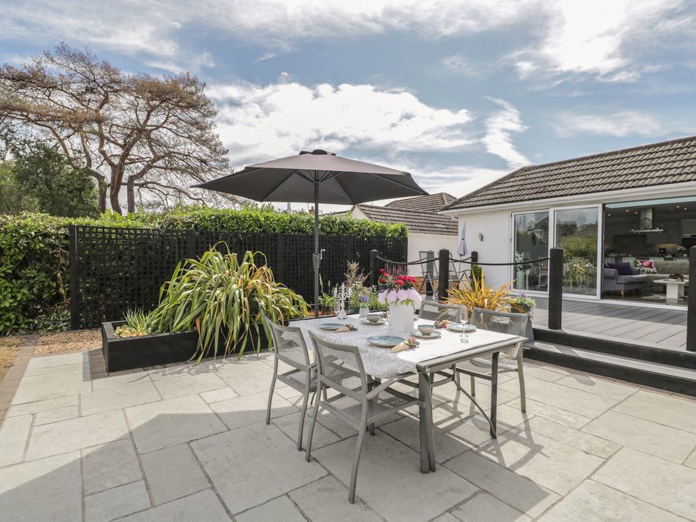 An outdoor dining area with table and chairs at The Laurels in Wimborne Minster