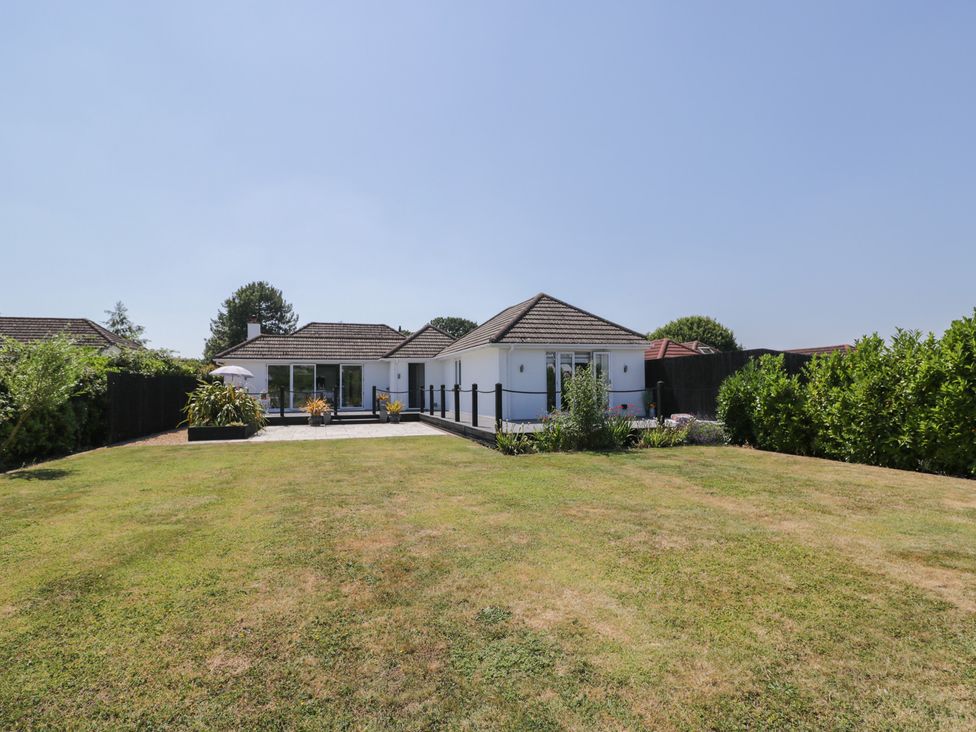 A house with a lawn and patio area at The Laurels in Wimborne Minster