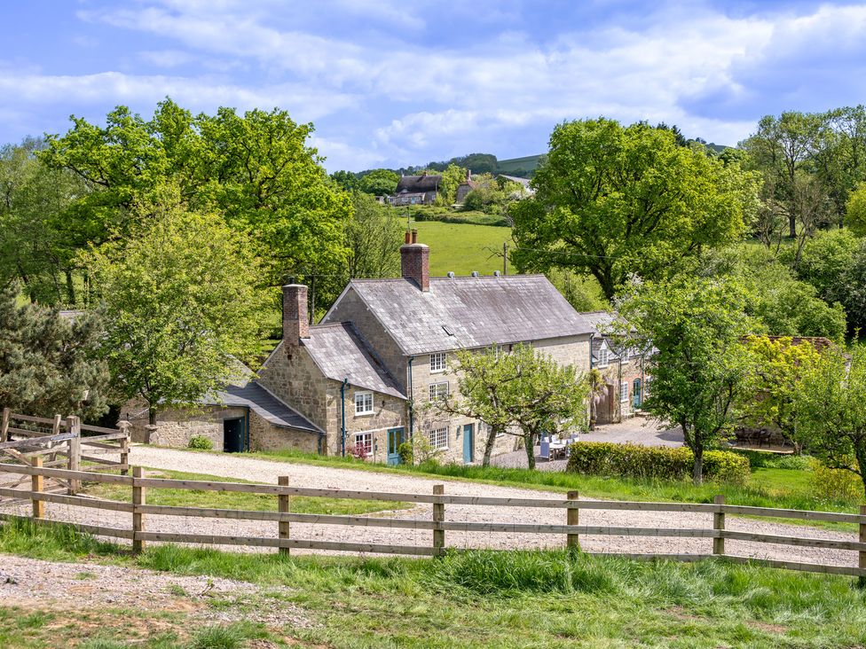 An outdoor view of a house surrounded by trees at French Mill in Shaftesbury