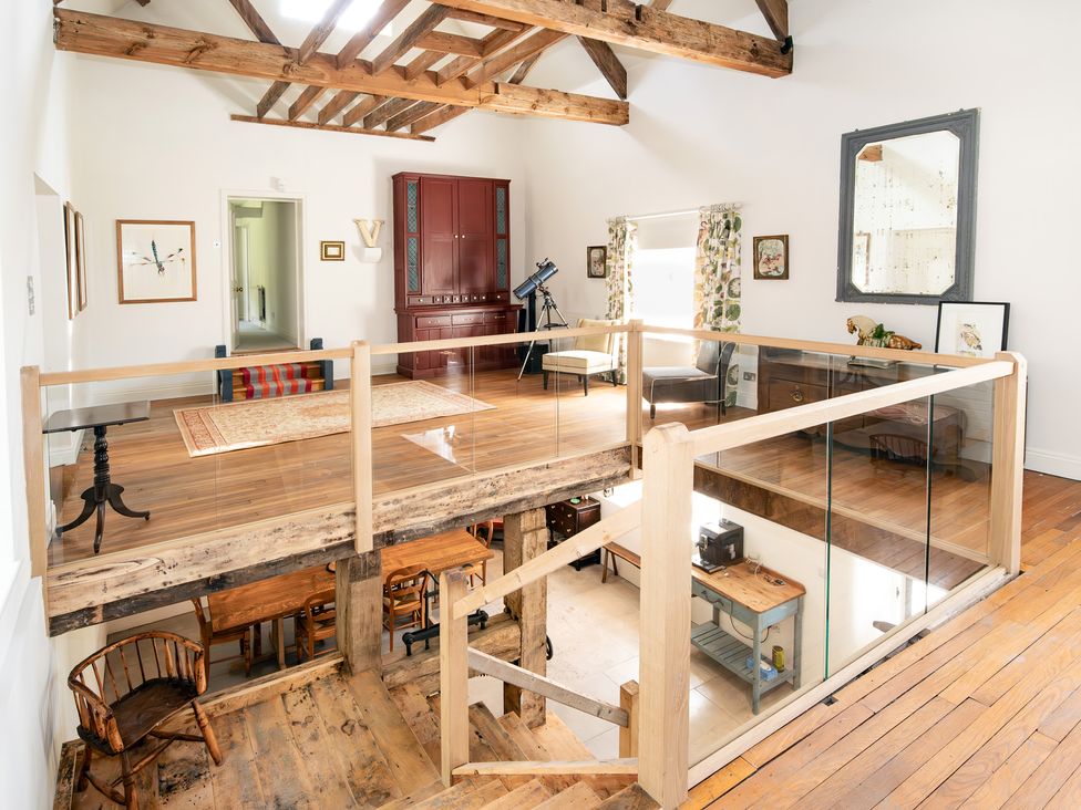 A living room with a balcony and telescope at French Mill in Shaftesbury