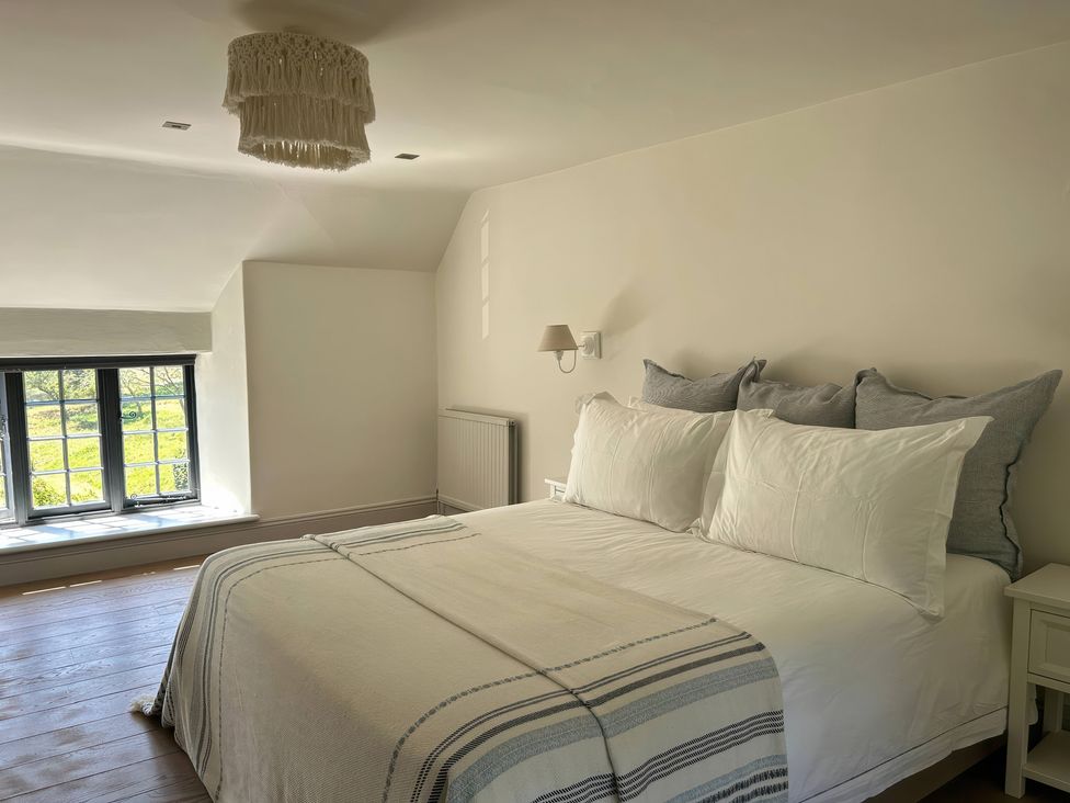 A bedroom with a bed and window at French Mill in Shaftesbury