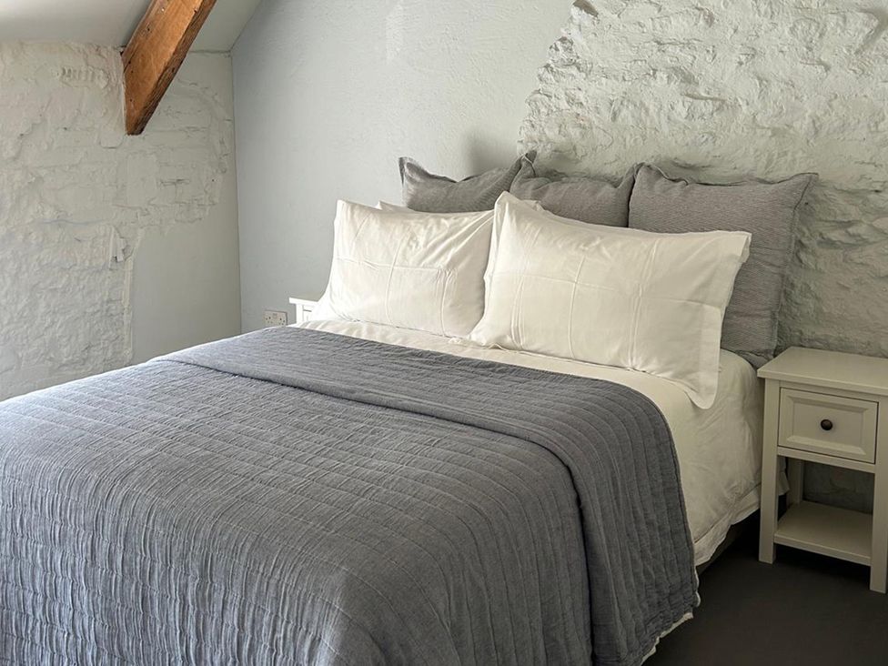 A bedroom with a bed and nightstand at French Mill in Shaftesbury