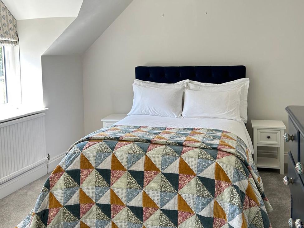 A bedroom with a bed and bedside table at French Mill in Shaftesbury
