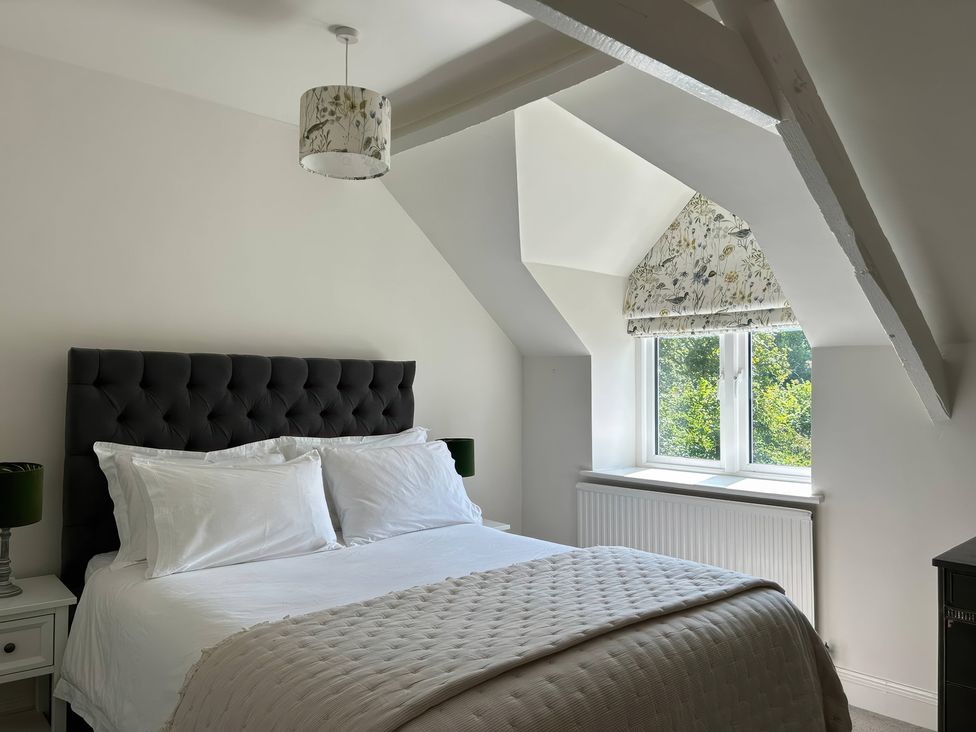 A bedroom with a bed and nightstand at French Mill in Shaftesbury