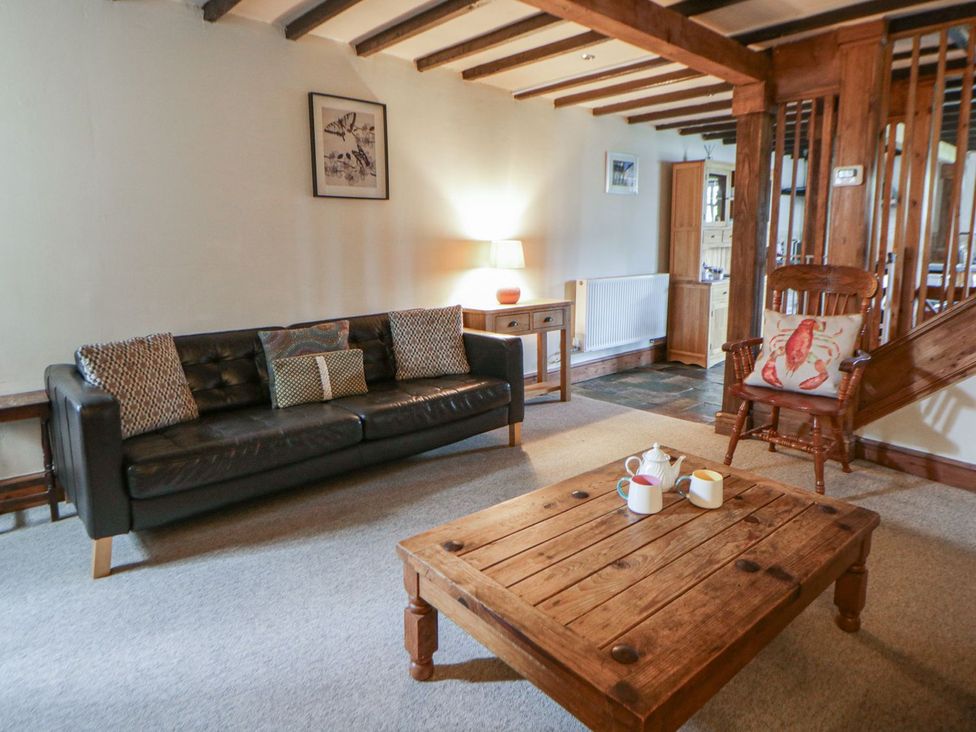 A living room with a sofa and coffee table at Dewi Villa Apartment in Aberaeron