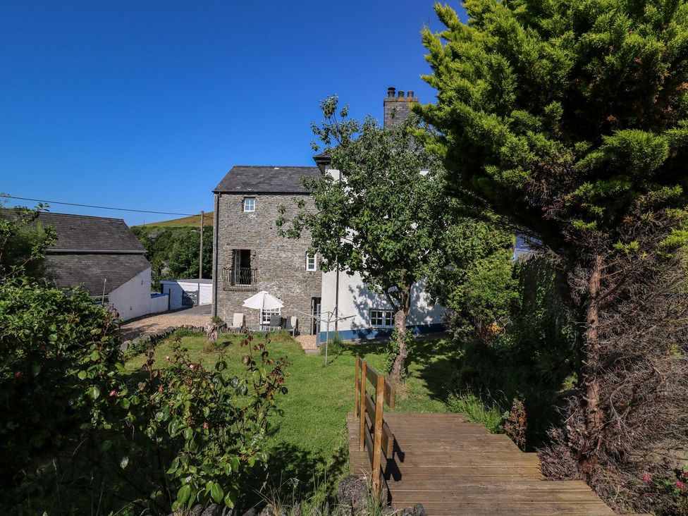A house with trees and a pathway at Dewi Villa Apartment Aberaeron