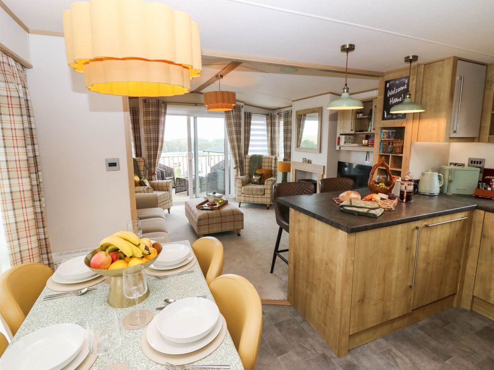 A kitchen with a dining table and chairs at The Manor’s Retreat in Dunbar