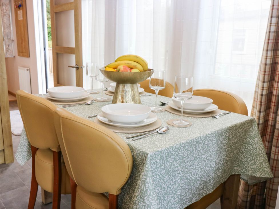 A dining table set with plates and glassware at The Manor’s Retreat Dunbar