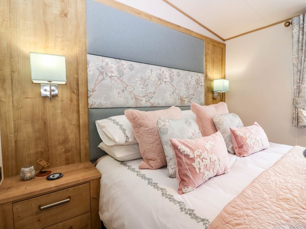 A bedroom with a bed and bedside table at The Manor’s Retreat in Dunbar