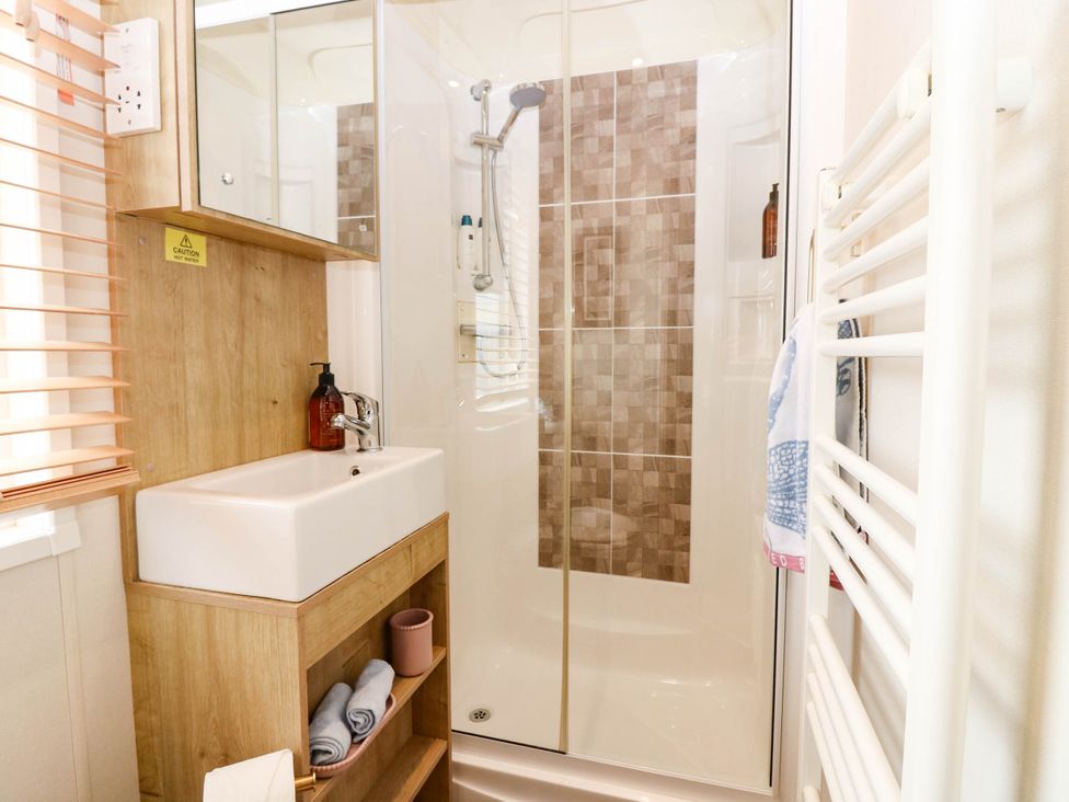 A bathroom with shower and sink at The Manor’s Retreat in Dunbar