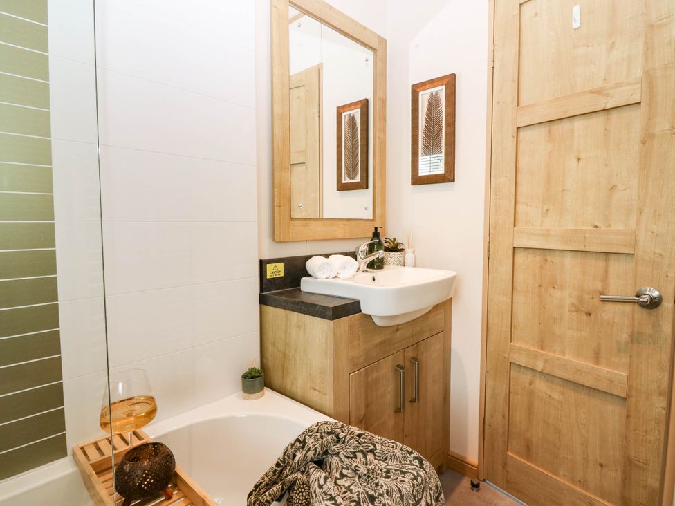 A bathroom with a sink and bathtub at The Manor’s Retreat in Dunbar