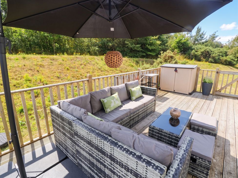 An outdoor seating area with a sofa and table at The Manor’s Retreat in Dunbar