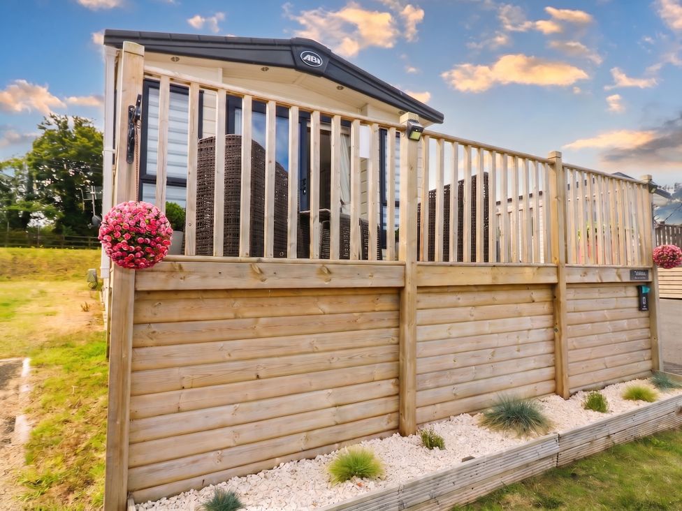 An outdoor area with wooden decking and a flower arrangement at The Manor’s Retreat in Dunbar