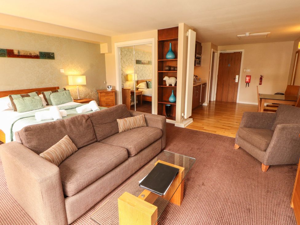 A living room with a bed and seating area at Ullswater Apartment- No 15