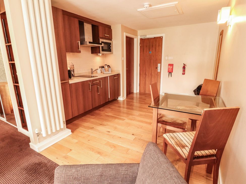A kitchen with a table and chairs at Ullswater Apartment- No 15