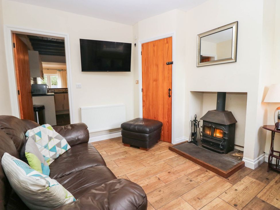 A living room with a sofa and fireplace at Bramble near Cleator Moor