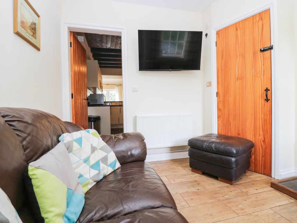 A living room with a sofa and television at Bramble near Cleator Moor