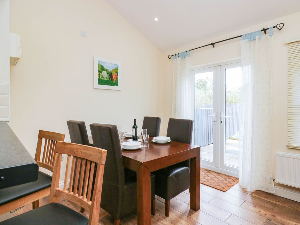 A dining room with a table set for a meal at Bramble near Cleator Moor