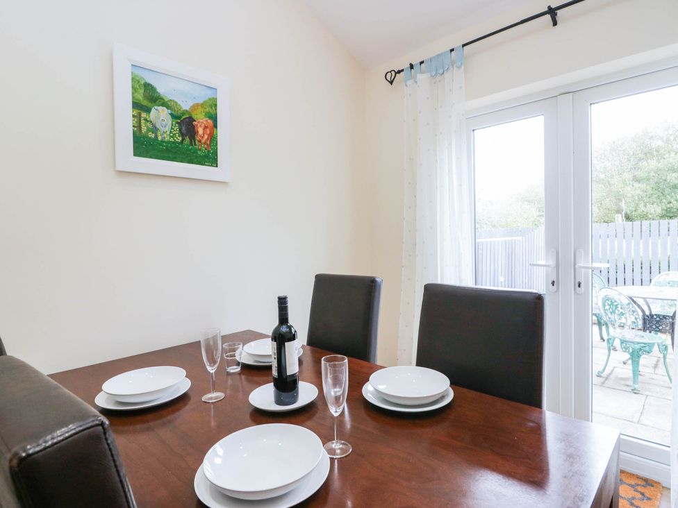 A dining room with a table set for dinner at Bramble near Cleator Moor