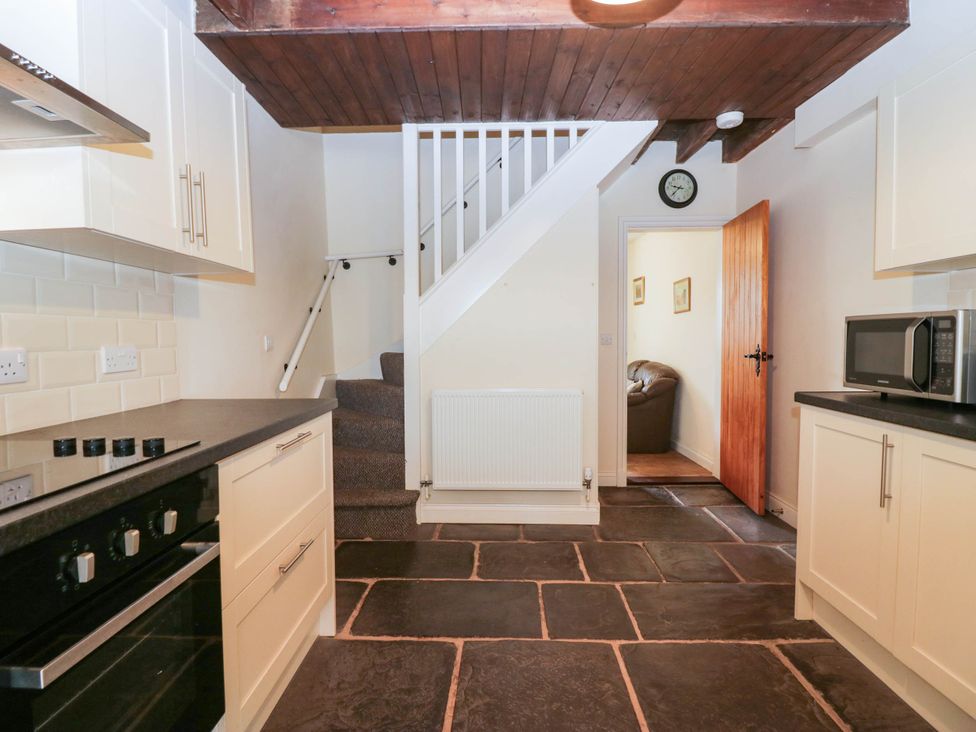 A kitchen with staircase and appliances at Bramble near Cleator Moor